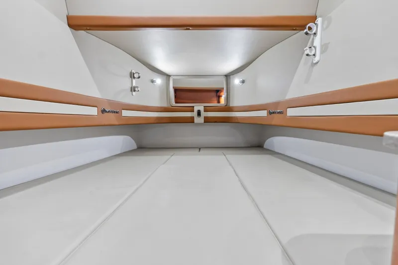 Slide: The Image of 2021 Mystic Powerboats M4200 cabin interior with sleek, modern design and comfortable seating. - 25