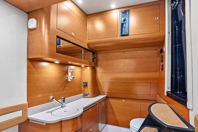 Slide: The Image of Luxurious 2021 Mystic Powerboats M4200 interior with modern wood cabinetry and sleek fixtures. - 26