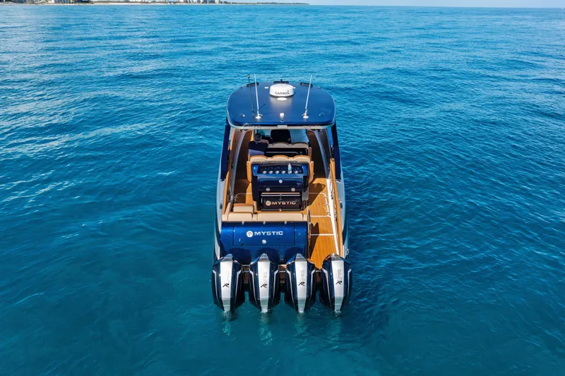 Slide: The Image of 2021 Mystic Powerboats M4200 on open water, showcasing sleek design and powerful engines. - 5