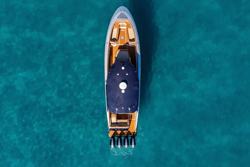 Slide: The Image of Aerial view of 2021 Mystic Powerboats M4200 on clear blue water. - 7