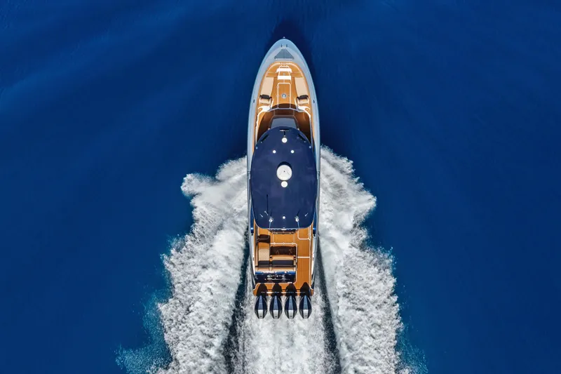 Slide: The Image of 2021 Mystic Powerboats M4200 cruising on open blue water, aerial view. - 9
