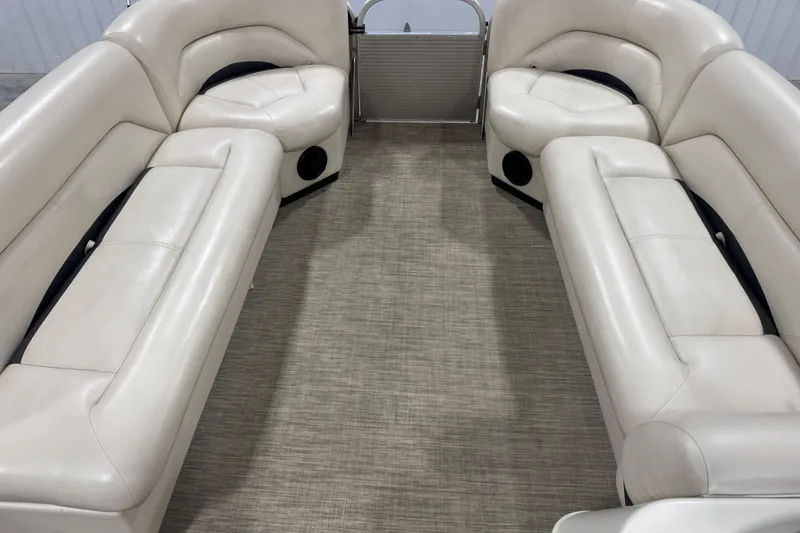 Slide: The Image of Interior of 2018 Landau Atlantis 250 pontoon boat with beige seating and carpet. - 13