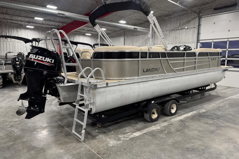 Slide: The Image of 2018 Landau Atlantis 250 pontoon boat with Suzuki outboard motor in a showroom. - 3