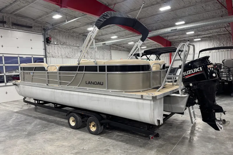 Slide: The Image of 2018 Landau Atlantis 250 pontoon boat with Suzuki 150 outboard motor in a showroom. - 4