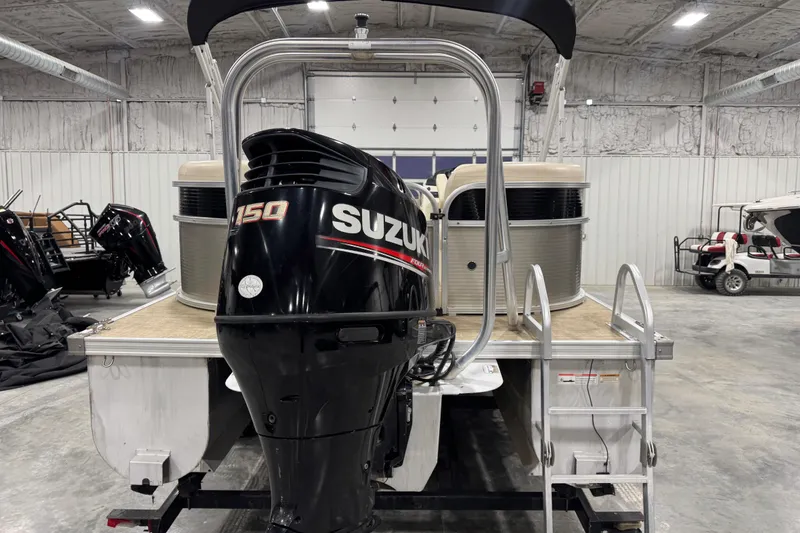 Slide: The Image of 2018 Landau Atlantis 250 pontoon boat with Suzuki 150 outboard motor in a warehouse. - 5