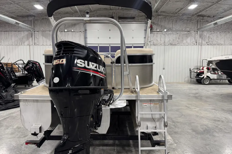 Slide: The Image of 2018 Landau Atlantis 250 pontoon boat with Suzuki 150 outboard motor in a warehouse. - 8