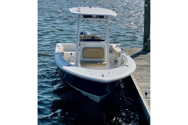 Slide: The Image of 2021 Sportsman Heritage 211 Center Console boat docked on calm water. - 3