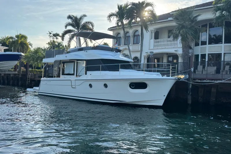 Slide: The Image of 2025 Beneteau Swift Trawler 41 Fly cruising on open blue sea. - 2