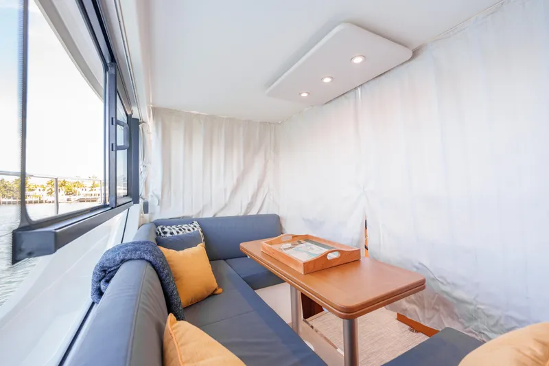 Slide: The Image of Interior view of 2025 Beneteau Swift Trawler 41 Fly, featuring modern kitchen and outdoor seating. - 23