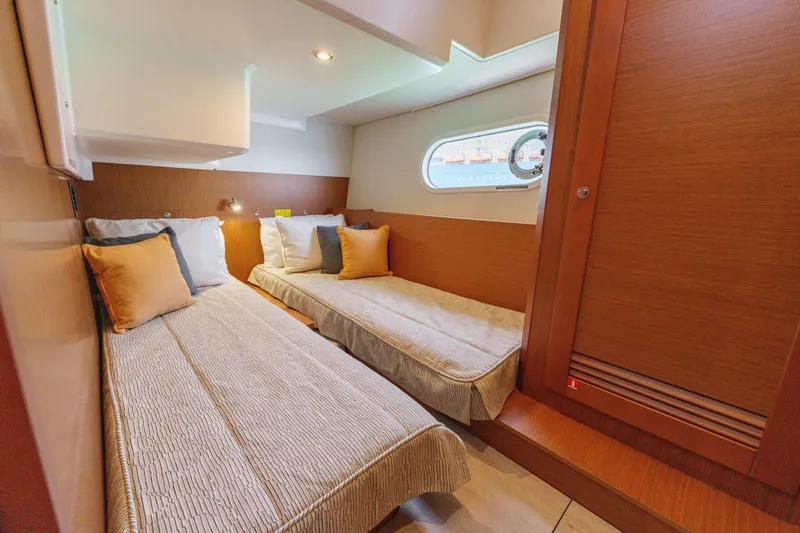 Slide: The Image of 2025 Beneteau Swift Trawler 41 Fly interior with wooden stairs and cozy seating area. - 33