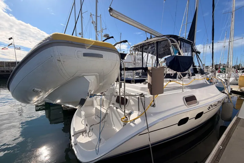Slide: The Image of 2004 Hunter Passage 420 sailboat docked with inflatable dinghy attached. - 11
