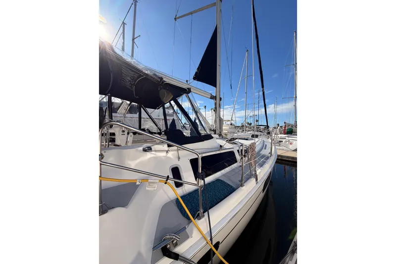 Slide: The Image of 2004 Hunter Passage 420 sailboat docked at marina under clear blue sky. - 13