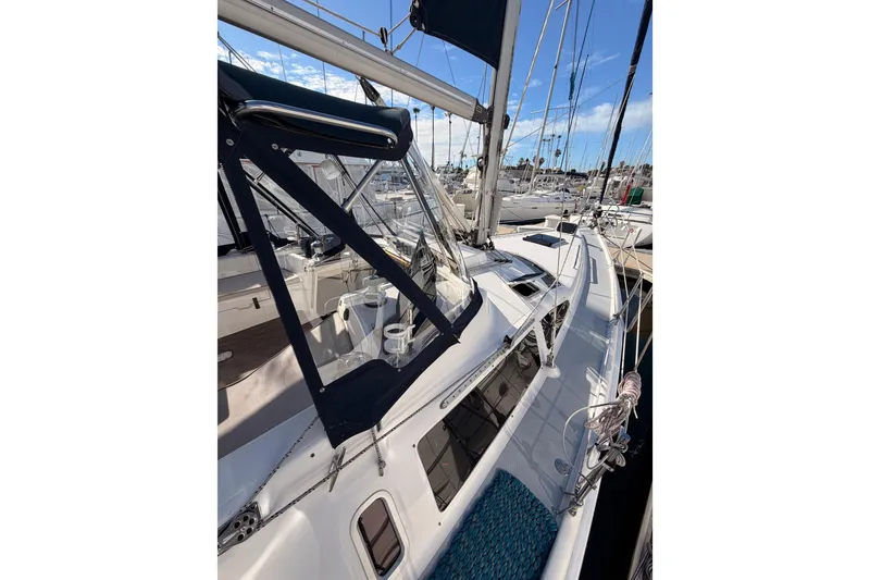 Slide: The Image of 2004 Hunter Passage 420 sailboat docked at marina, featuring spacious deck and sleek design. - 14