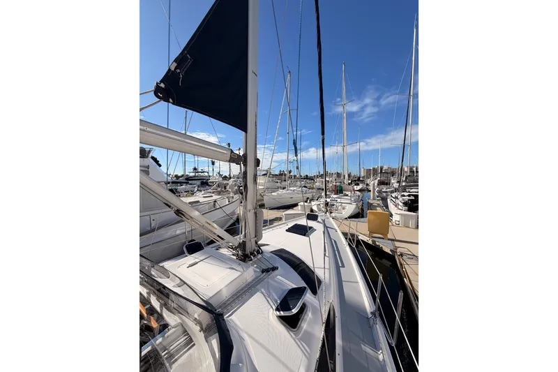 Slide: The Image of 2004 Hunter Passage 420 sailboat docked in a marina under a clear blue sky. - 15