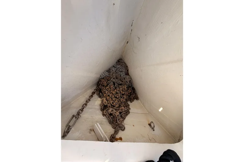 Slide: The Image of Anchor chain storage in a 2004 Hunter Passage 420 sailboat. - 19