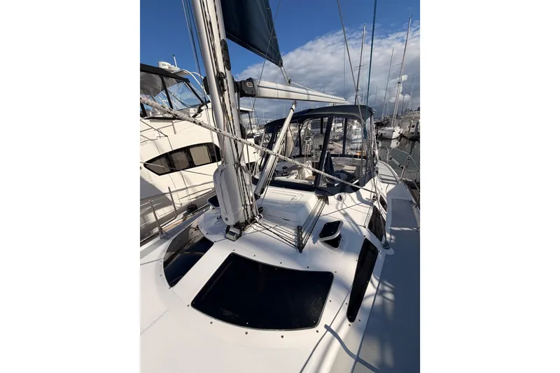 Slide: The Image of 2004 Hunter Passage 420 sailboat docked at marina under clear blue sky. - 23