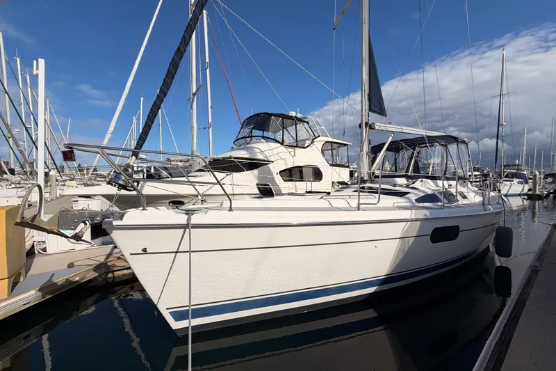 Slide: The Image of 2004 Hunter Passage 420 sailboat docked at marina under clear blue sky. - 3