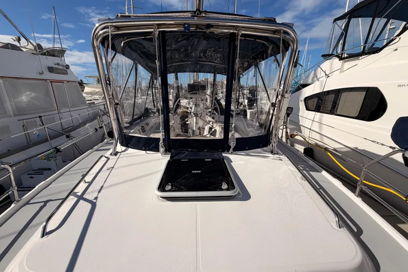 Slide: The Image of 2004 Hunter Passage 420 sailboat docked at marina, featuring a sleek deck and clear canopy. - 30