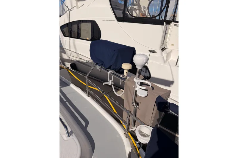 Slide: The Image of 2004 Hunter Passage 420 yacht deck with covered equipment and railing details. - 31