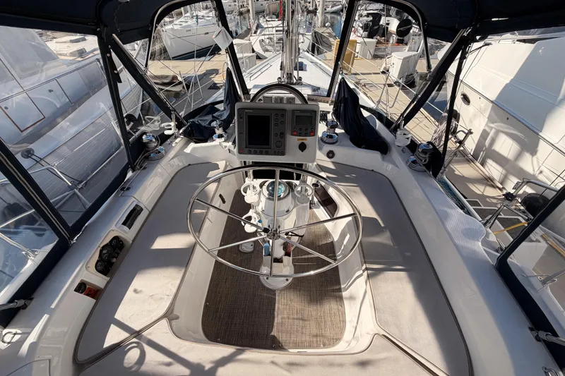 Slide: The Image of Cockpit of 2004 Hunter Passage 420 sailboat with steering wheel and navigation equipment. - 32