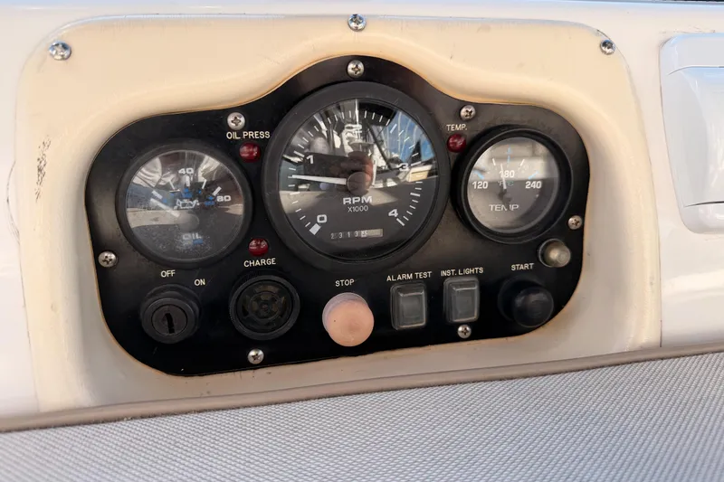 Slide: The Image of Control panel of a 2004 Hunter Passage 420 sailboat, featuring gauges and switches. - 38