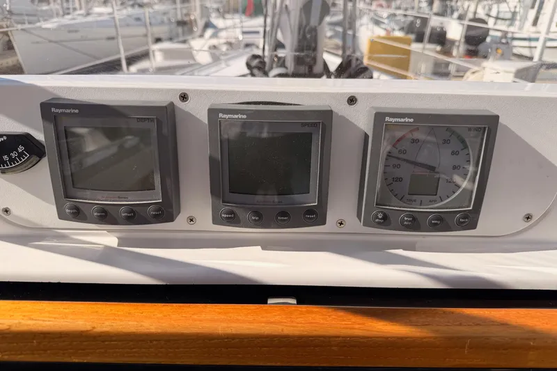 Slide: The Image of Raymarine navigation instruments on a 2004 Hunter Passage 420 sailboat dashboard. - 42