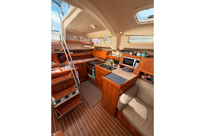 Slide: The Image of Interior of 2004 Hunter Passage 420 sailboat with wooden cabinetry and modern amenities. - 47