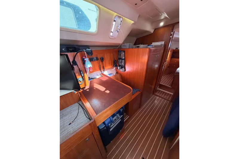 Slide: The Image of 2004 Hunter Passage 420 yacht interior with wooden cabinetry and navigation station. - 55