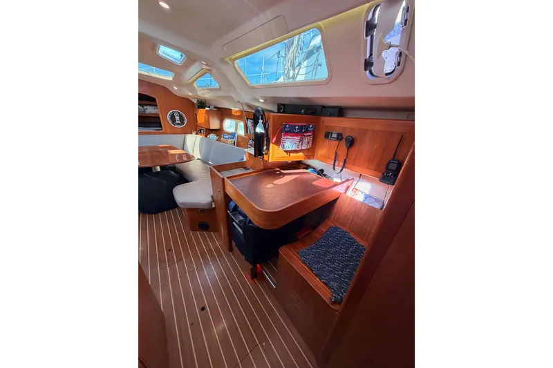 Slide: The Image of 2004 Hunter Passage 420 yacht interior with wooden furnishings and navigation equipment. - 56