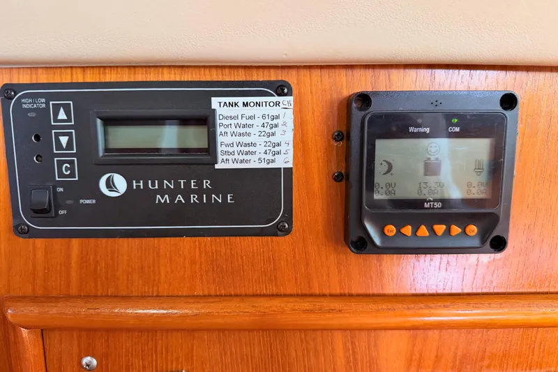 Slide: The Image of Control panel of a 2004 Hunter Passage 420 sailboat with tank monitor and display. - 60