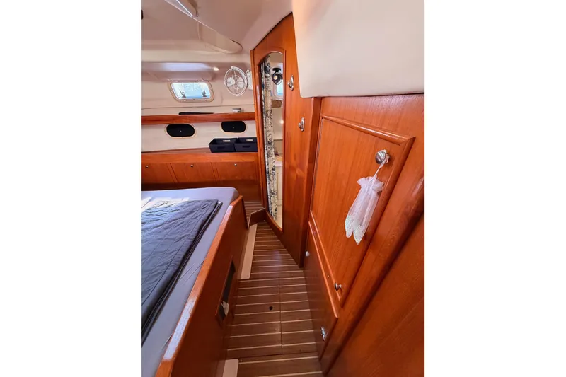 Slide: The Image of Interior of 2004 Hunter Passage 420 yacht with wooden cabinetry and cozy sleeping area. - 66