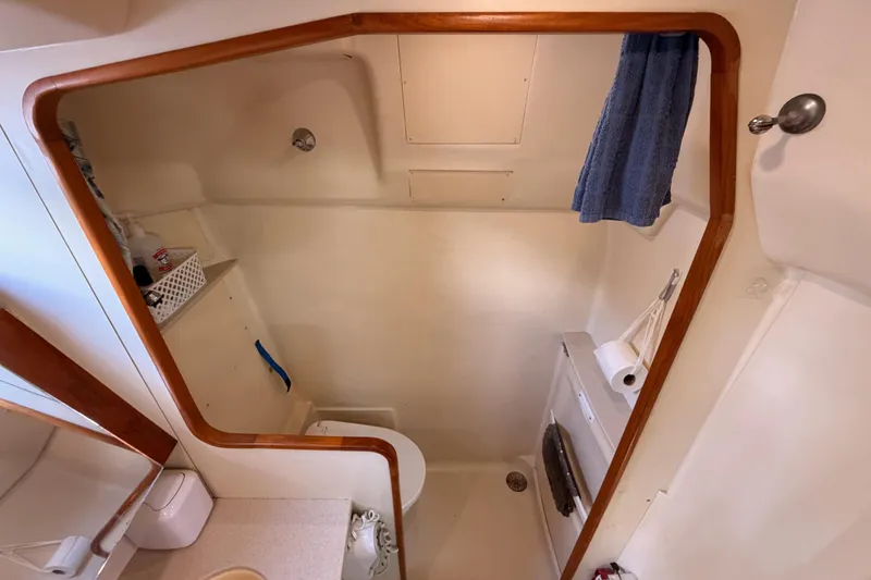 Slide: The Image of Bathroom interior of 2004 Hunter Passage 420 sailboat, featuring shower and toilet. - 68