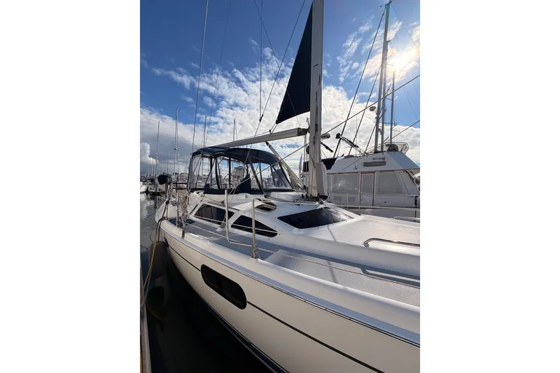 Slide: The Image of 2004 Hunter Passage 420 sailboat docked under a bright blue sky. - 7