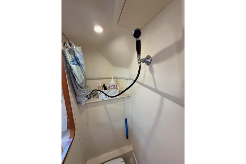 Slide: The Image of 2004 Hunter Passage 420 yacht shower with curtain and toiletries. - 70
