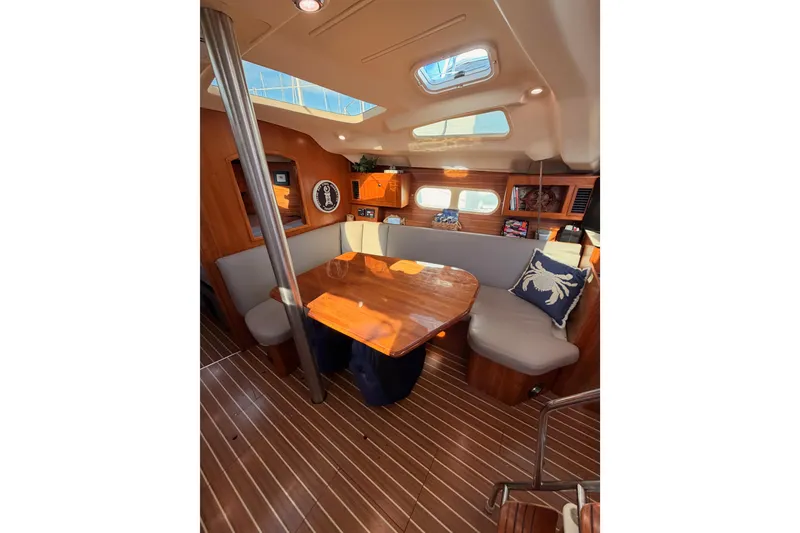 Slide: The Image of Interior of 2004 Hunter Passage 420 yacht with wooden table and seating area. - 77
