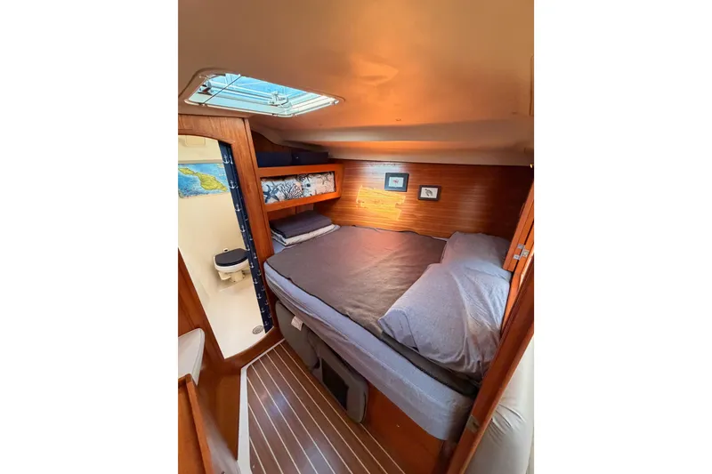 Slide: The Image of Cozy cabin interior of 2004 Hunter Passage 420 sailboat with skylight and wooden accents. - 79