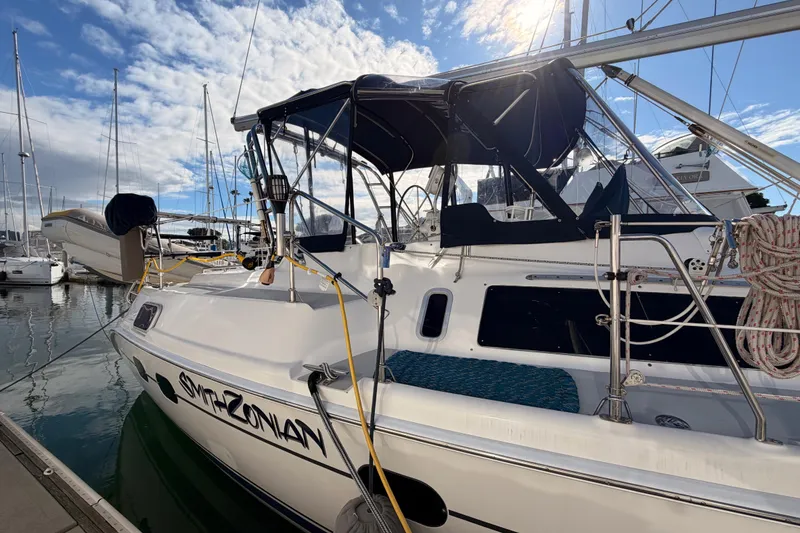 Slide: The Image of 2004 Hunter Passage 420 sailboat docked at marina under blue sky. - 8
