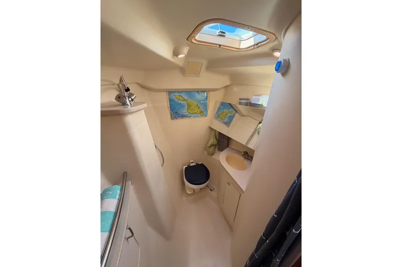 Slide: The Image of 2004 Hunter Passage 420 yacht bathroom with skylight, sink, and nautical decor. - 81
