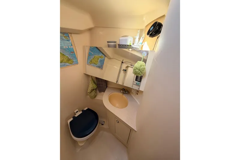 Slide: The Image of Compact bathroom in 2004 Hunter Passage 420 sailboat, featuring sink, toilet, and mirror. - 82
