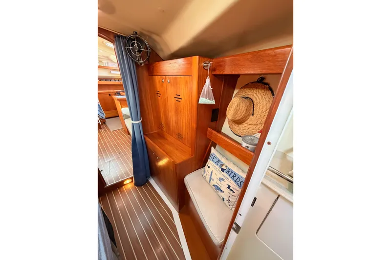 Slide: The Image of Interior of 2004 Hunter Passage 420 sailboat with wooden cabinetry and nautical decor. - 84