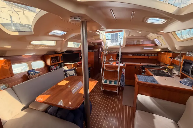 Slide: The Image of Interior of 2004 Hunter Passage 420 yacht, featuring a spacious, well-lit cabin with modern amenities. - 86