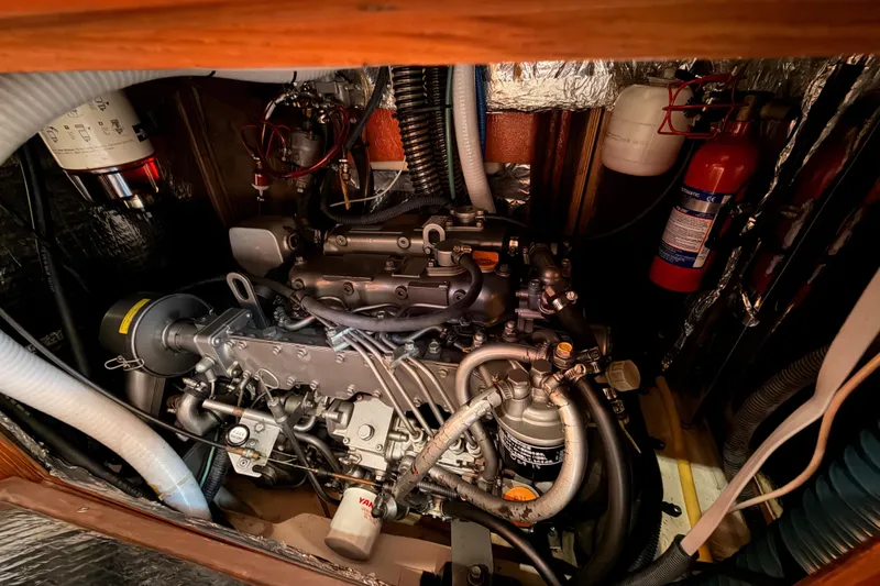 Slide: The Image of Engine compartment of a 2004 Hunter Passage 420 sailboat, featuring detailed mechanical components. - 87