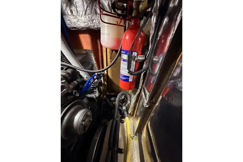 Slide: The Image of Engine compartment of 2004 Hunter Passage 420 with fire extinguisher and mechanical components. - 89