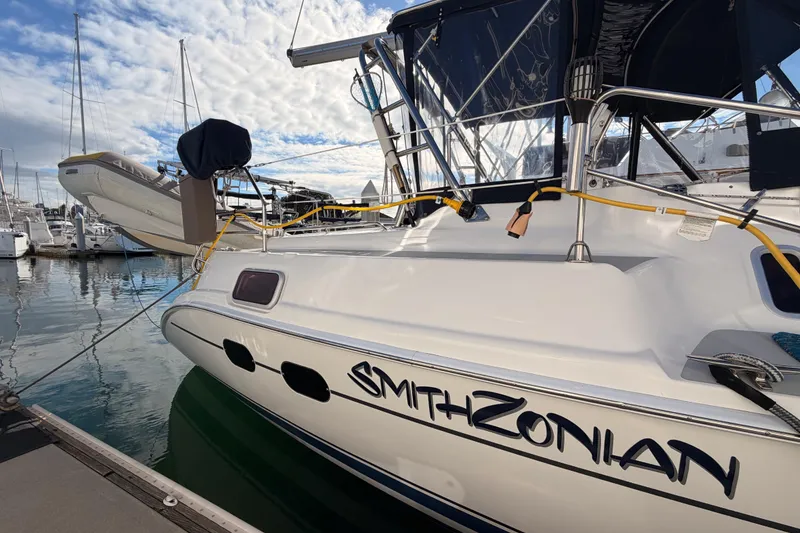 Slide: The Image of 2004 Hunter Passage 420 yacht docked at marina under blue sky. - 9