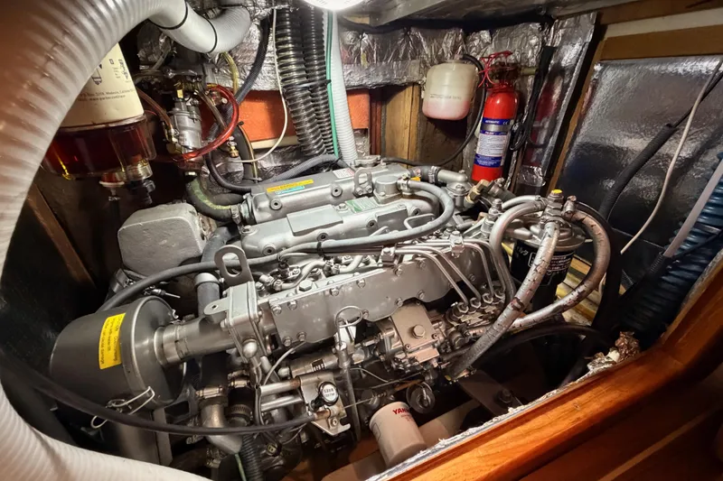 Slide: The Image of Engine compartment of a 2004 Hunter Passage 420 sailboat, featuring detailed mechanical components. - 90