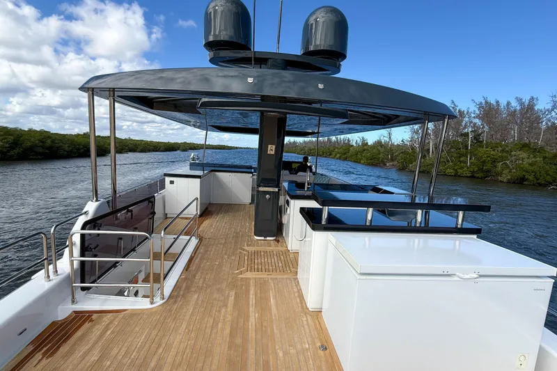 Slide: The Image of Luxurious 2023 Sirena 68 yacht deck with sleek design and scenic river view. - 12