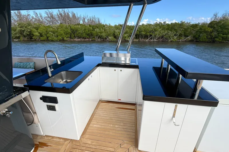 Slide: The Image of Outdoor kitchen on 2023 Sirena 68 yacht with sink, grill, and bar area. - 13
