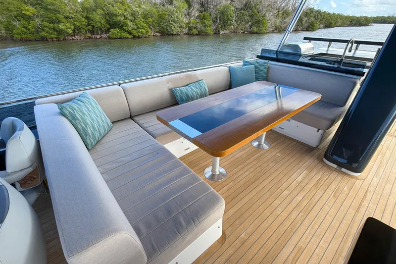 Slide: The Image of Luxurious seating area on 2023 Sirena 68 yacht with elegant table and scenic water view. - 16