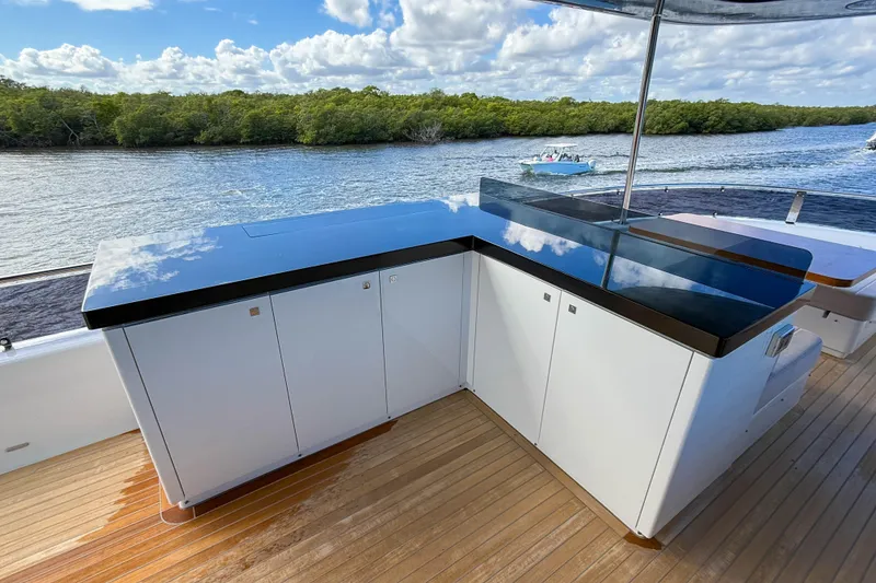 Slide: The Image of Luxury Sirena 68 yacht deck with sleek cabinetry, 2023 model, scenic water view. - 17