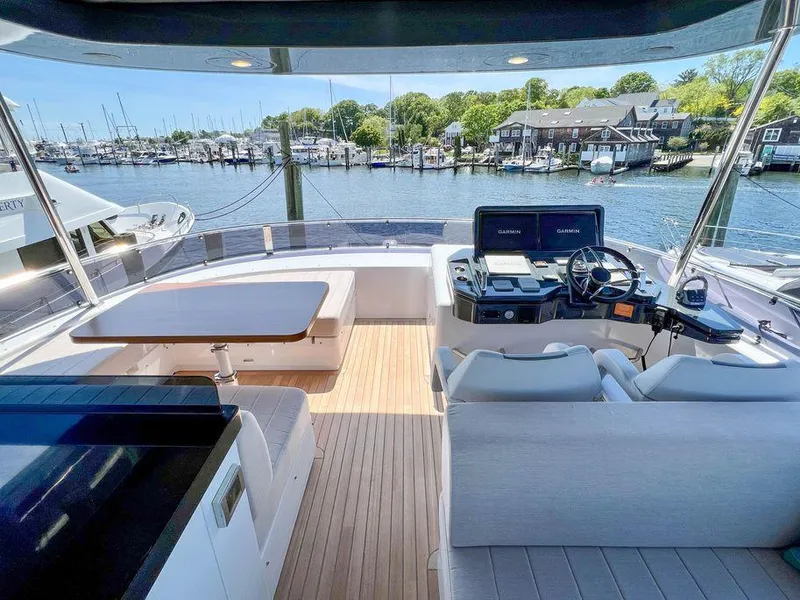 Slide: The Image of Luxury 2023 Sirena 68 yacht interior with helm, seating, and waterfront view. - 18